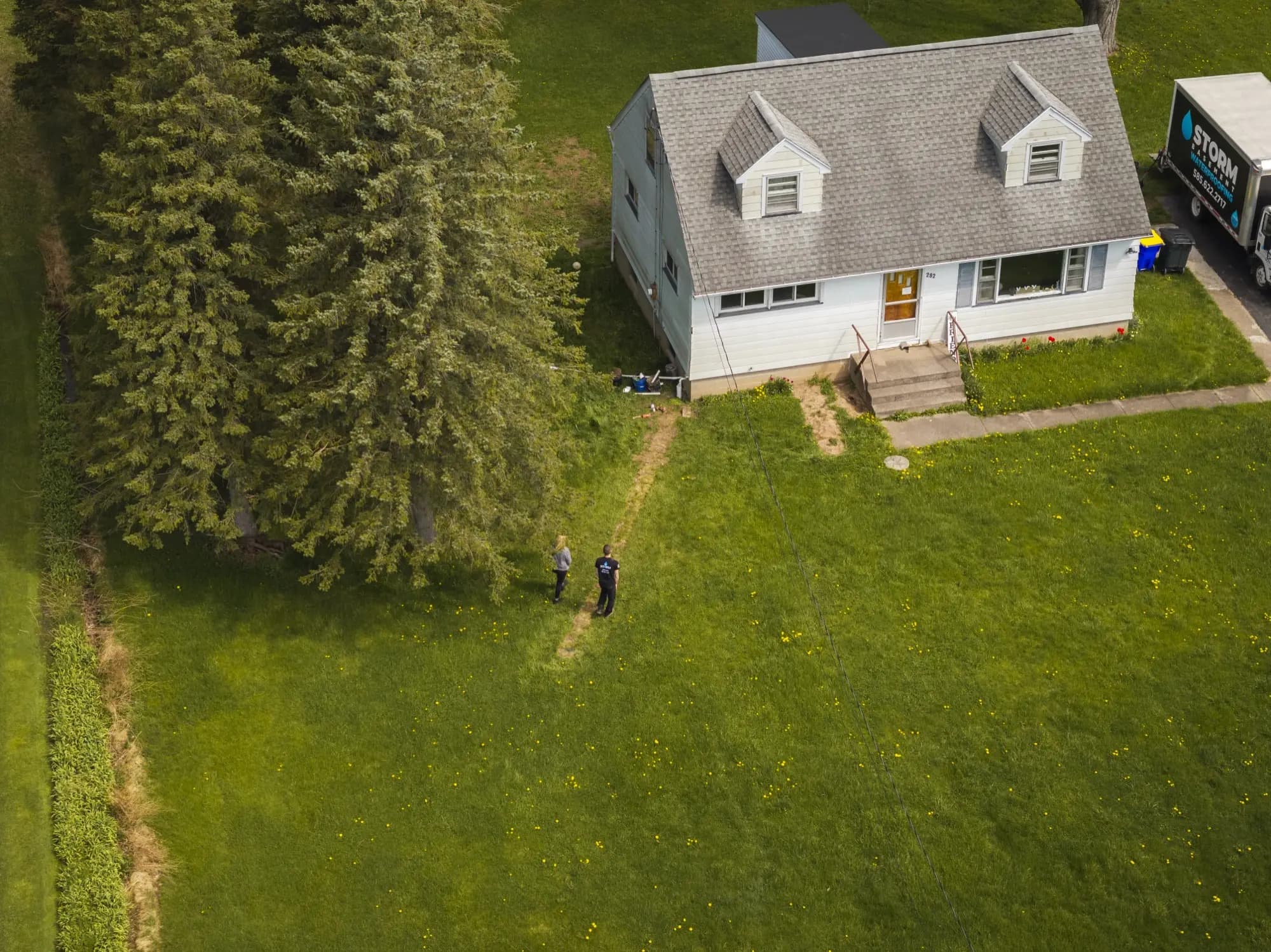 Storm team installing discharge line with proper grading