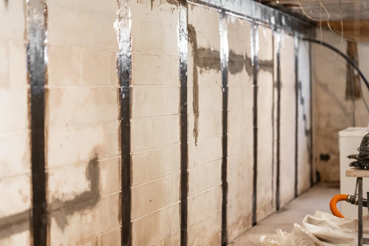 Carbon fiber straps reinforcing basement block wall
